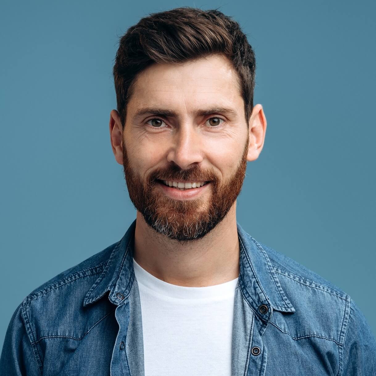 portrait of cheerful handsome man in denim shirt s ZXG9M4P